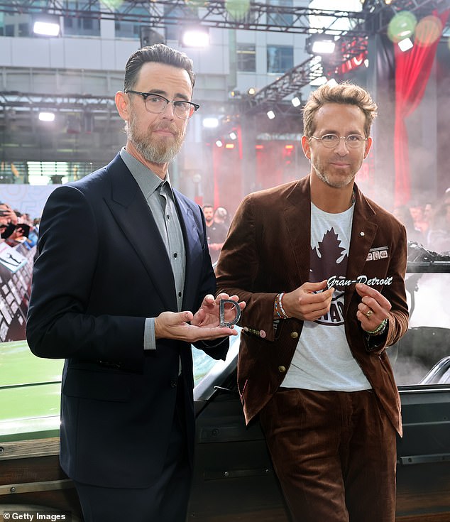 The colleagues posed together with small mementos