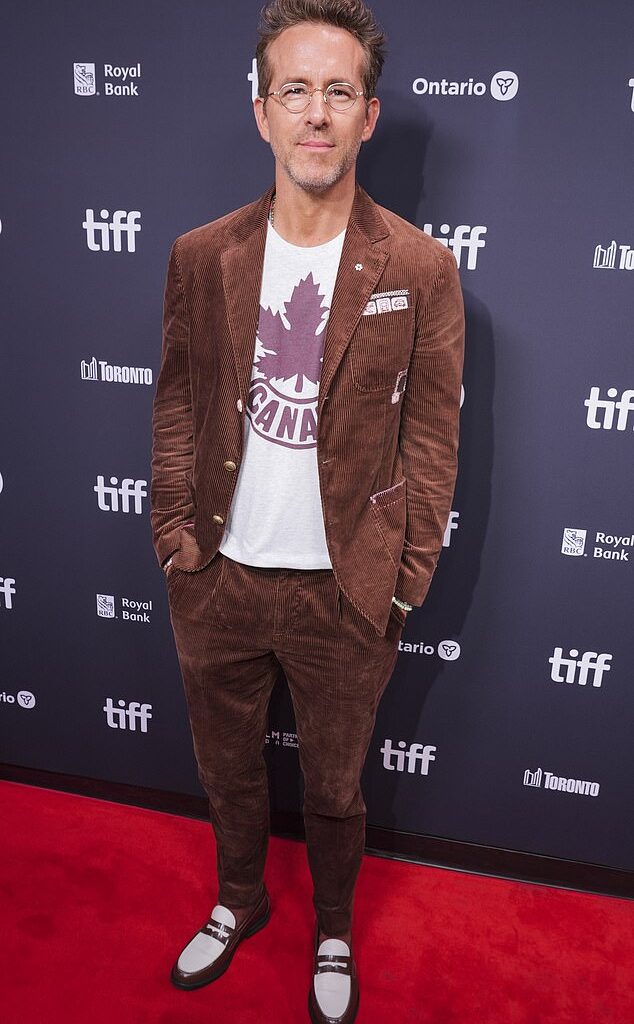 Ryan Reynolds cut a dapper figure in a casual suit when he joined Tom Hanks' nepo baby son Colin Hanks on the red carpet at the Toronto International Film Festival on Thursday evening