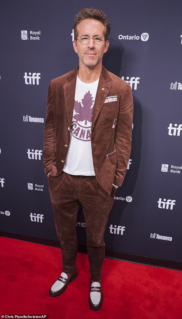 Ryan Reynolds cut a dapper figure in a casual suit when he joined Tom Hanks' nepo baby son Colin Hanks on the red carpet at the Toronto International Film Festival on Thursday evening