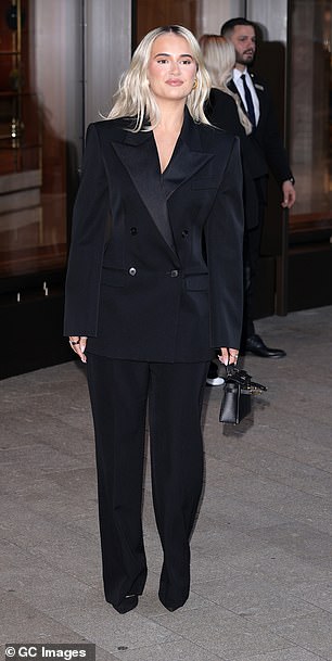 She added a black Hermès Mini Kelly bag to her look which retails at a whopping £23,000