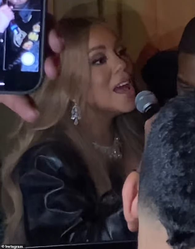 The 56-year-old chart-topping singer was holding up a microphone as she crooned the 2002 tune I Know What You Want next to rapper Busta Rhymes