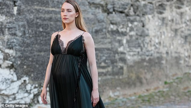 The Little Women star, 31, and her actor husband, 35, were spotted enjoying a low-key stroll in London while pushing their buggy earlier this month (pictured in May while unveiling her bump)