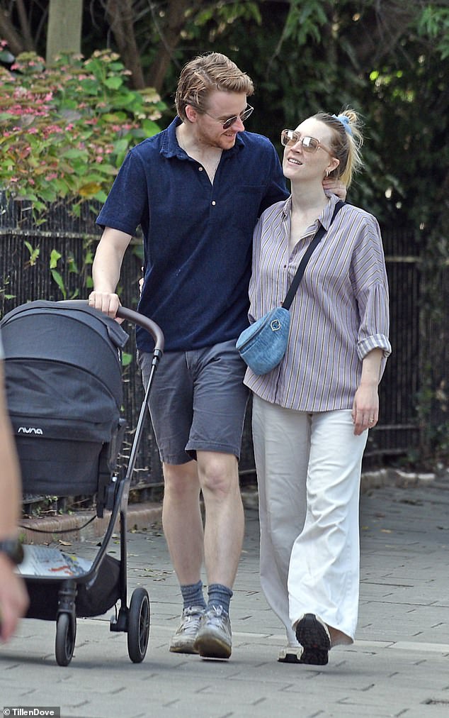 The new parents cosied up together as they walked along with their Nuna buggy, which costs around £1.2k with all the added accessories