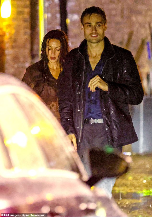 Battling the elements to film the tense drama, Michelle was dressed in a brown blouse and a matching skirt as she and Douglas filmed the late-night scenes