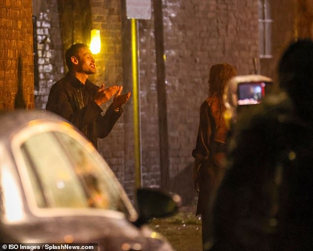 The pair were seen verbally clashing the torrential weather outside a corner shop in Hertford
