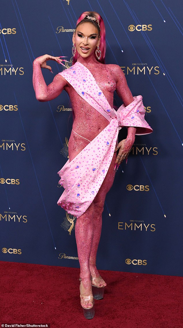 Lexi Love, 34, of RuPaul's Drag Race fame, left very little to the imagination in a skimpy pink coverup draped across her body - having been coated head-to-toe in pink glitter - before finishing the look in sky-high heels