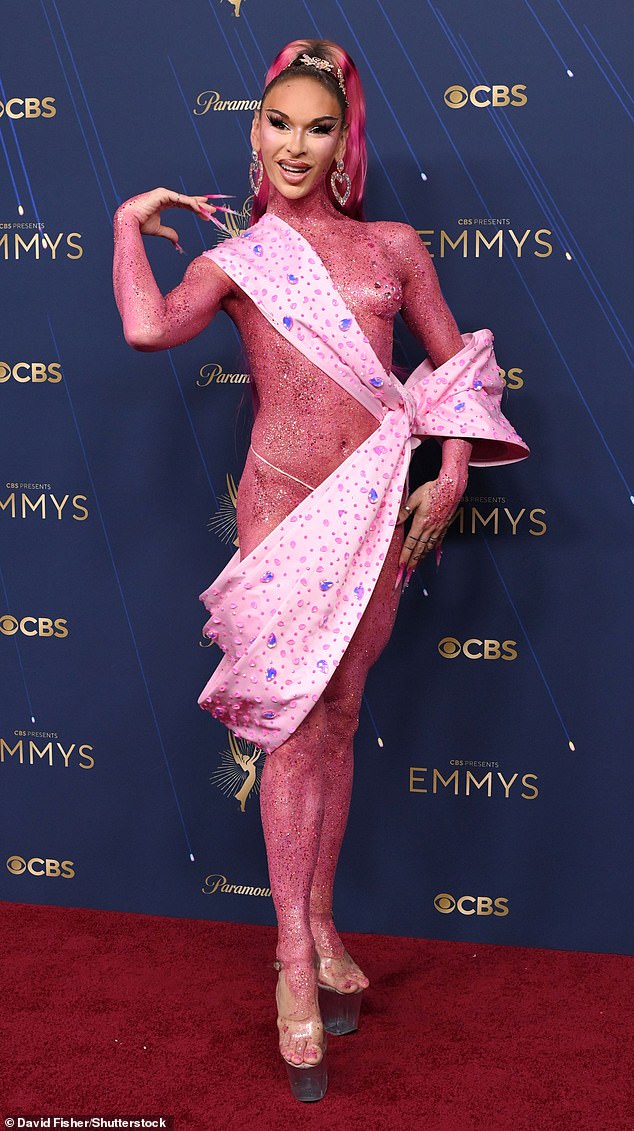 Lexi Love, 34, of RuPaul's Drag Race fame, left very little to the imagination in a skimpy pink coverup draped across her body - having been coated head-to-toe in pink glitter - before finishing the look in sky-high heels