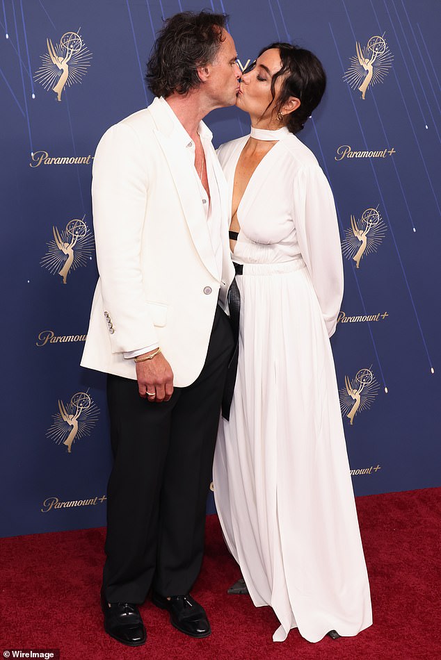Walton and Nadia shared a kiss on the red carpet, with the actor wearing a white and black Louis Vuitton suit