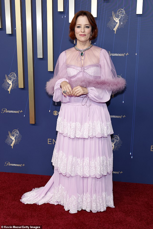 Renowned actress Parker Posey, 56, who most recently appeared in The White Lotus, arrived in an old fashioned frilly, tiered lilac gown that featured long sleeves and a sheer mini cape with a fur hem