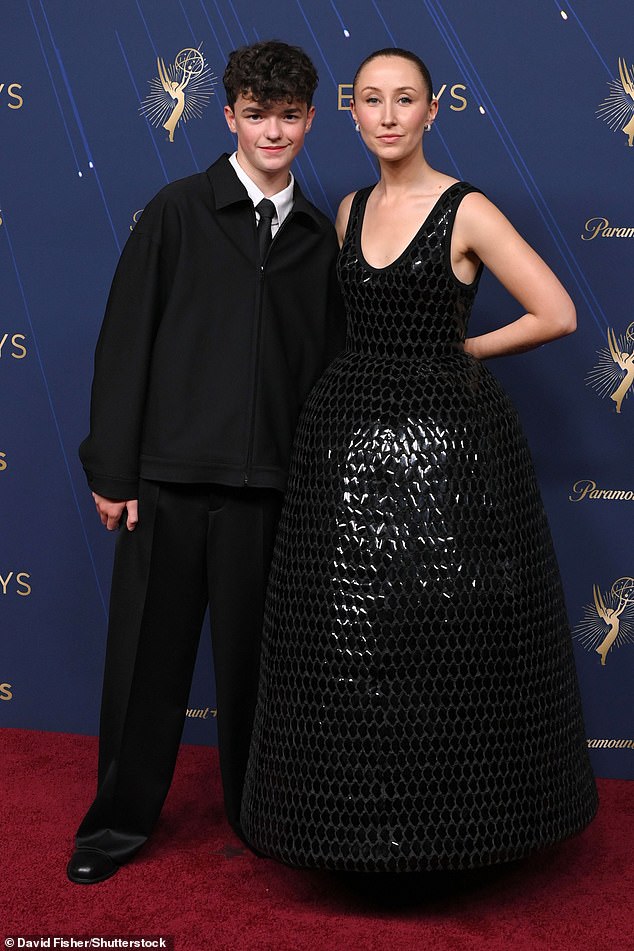 Erin looked sensational for the evening as she donned a black mirror effect sculpted gown with a full skirt while joined on the red carpet by her co-star Owen, 15