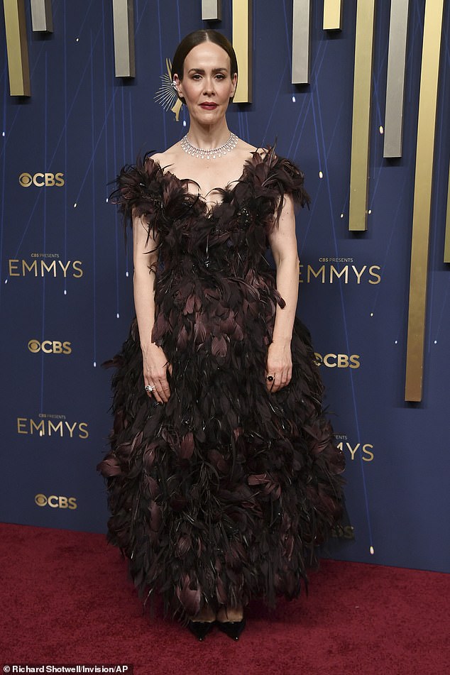 Beloved actress Sarah Paulson, 50, acclaimed for her roles in Ryan Murphy's series American Horror Story, arrived to the red carpet in a brown feathered ensemble that fluffed out into a unkempt ballooned skirt