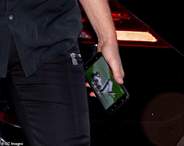 Cooper was seen streaming the Eagles game on his phone as they went on to beat the Chiefs