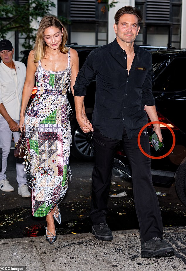 Bradley Cooper was a bit distracted as he stepped out with Gigi Hadid on Sunday