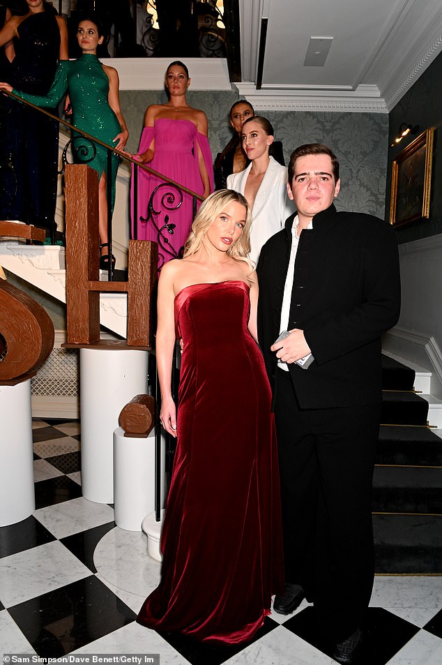 The 35-year-old donned a red velvet dress at the London Fashion Show event hosted by Chococo in partnership with fashion designer Josh Birch Jones (front right)