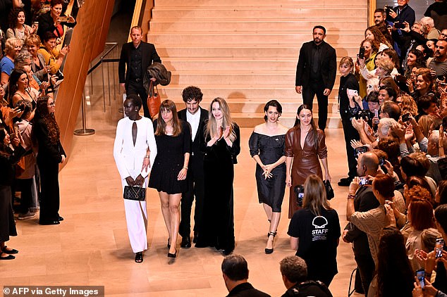 The stars were greeted by applause by fans outside