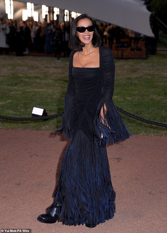 The presenter, 30, ensured all eyes were on her in an arresting black and navy gown that clung to every inch of her toned figure and displayed her ample cleavage