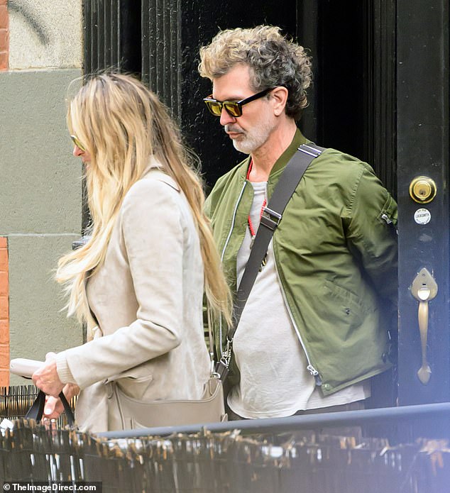 Elle kept a low profile as she opted for dark sunglasses and walked alongside Doyle, who dressed casually in brown pants and a khaki jacket