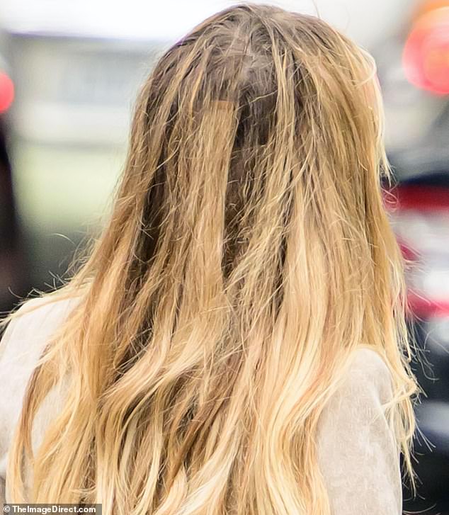 The 61-year-old model went on a shopping trip with Doyle in New York City and left one of her hair extension tapes exposed