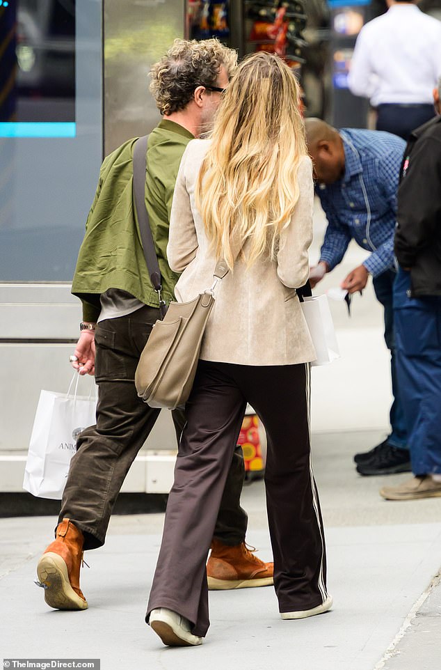 She seemed oblivious to the gaffe as she visited designer stores with her beau
