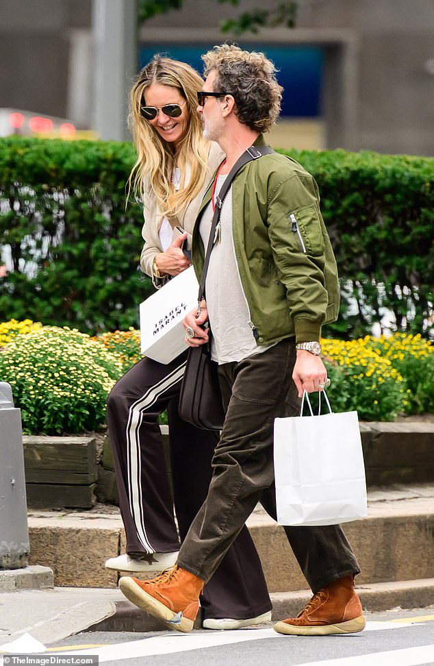 One extension was noticeable at the back of her head as she carried shopping bags through the streets