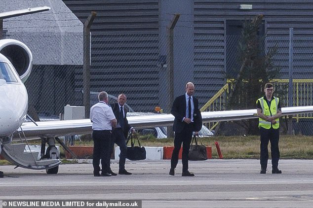 The Prince of Wales walks towards a waiting vehicle after landing in Aberdeen on Tuesday
