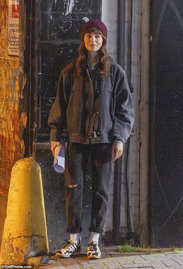 Lily was dressed in a burgundy beanie, a dark denim jacket and black and white Adidas trainers