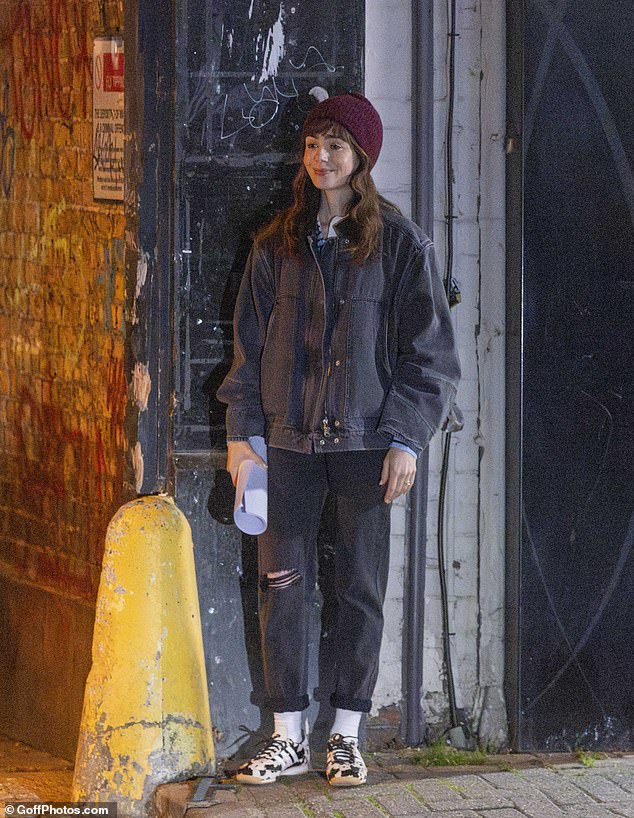 Lily looked chuffed in between takes, wearing a wry smile beneath her burgundy beanie hat