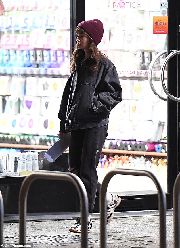The actress was spotted taking some time to look at the fancy dress shop next door between takes
