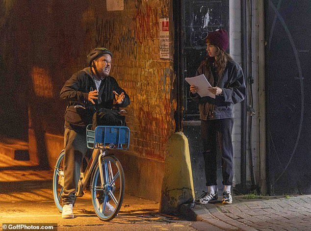 The man playing the character of the drug dealer pulls an amusing face as Lily looks at him in bewilderment