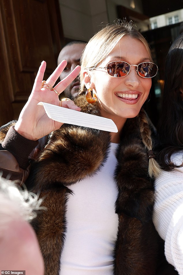 Bella Hadid flashed a huge smile as she stepped out at Paris Fashion Week on Monday