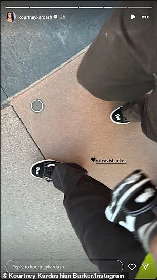 She also shared a snap of herself walking beside Travis as he held their 22-month-old toddler
