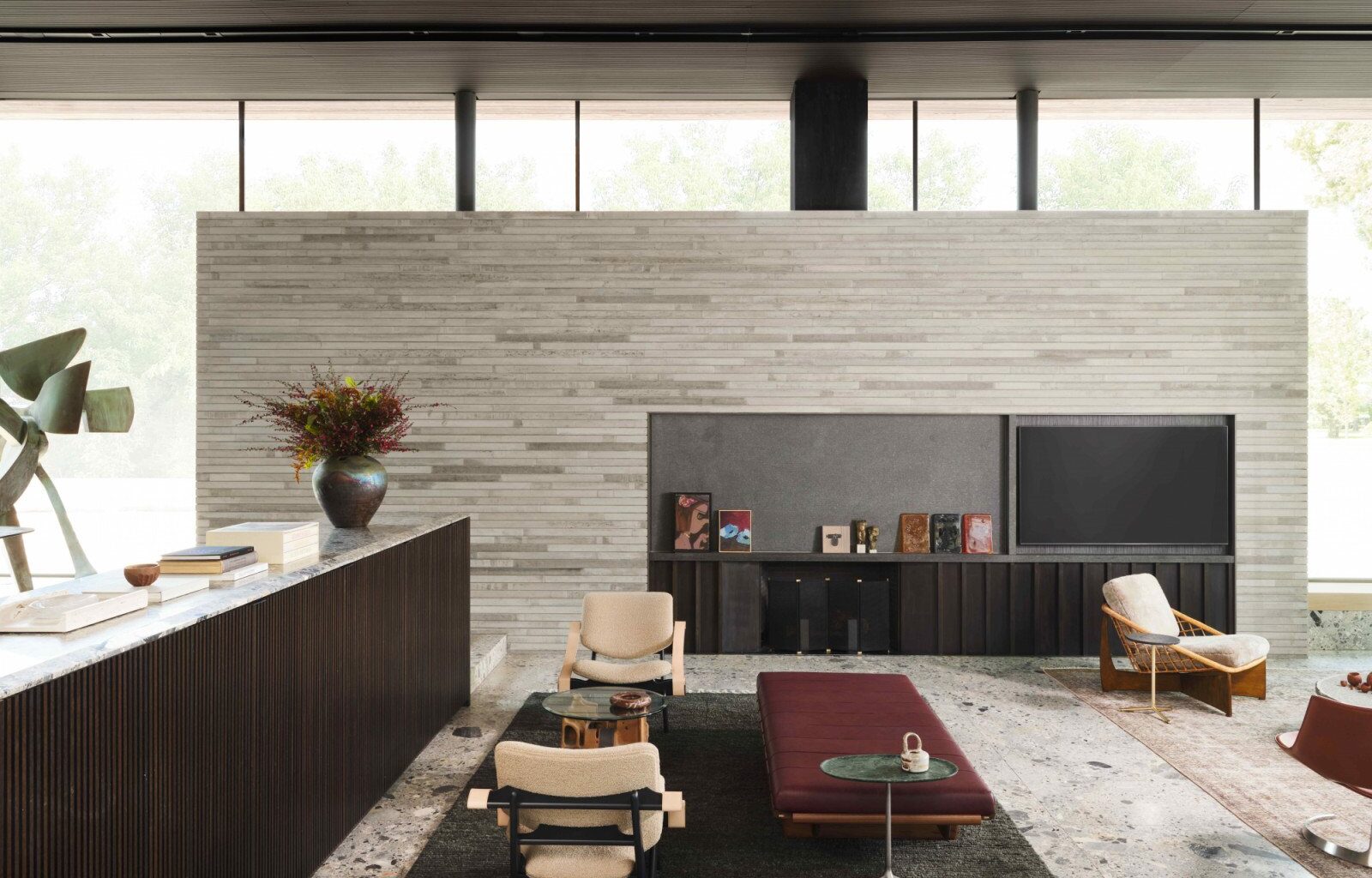 The darker grey ‘ceppo’ marble flooring in the sunken living room provides elegant contrast to the limestone walls