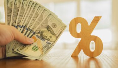 Percent symbol with people holding money that is many dollar bills. Concepts of the banking system, rising interest rates, inflation, deflation, and savings. stock photo
