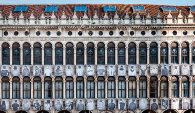 large-scale portraits of migrants transform venice's procuratie
