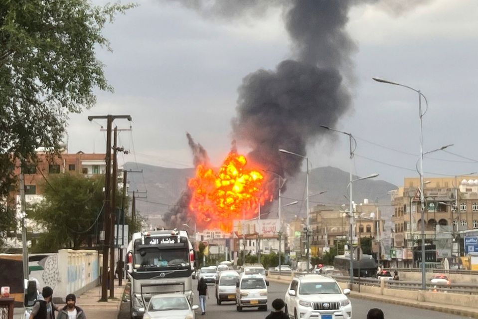 Flames and smoke rise following Israeli airstrikes on the Houthi defence ministry in the Yemeni capital, Sanaa. Military camps were also targeted. Photo: AP