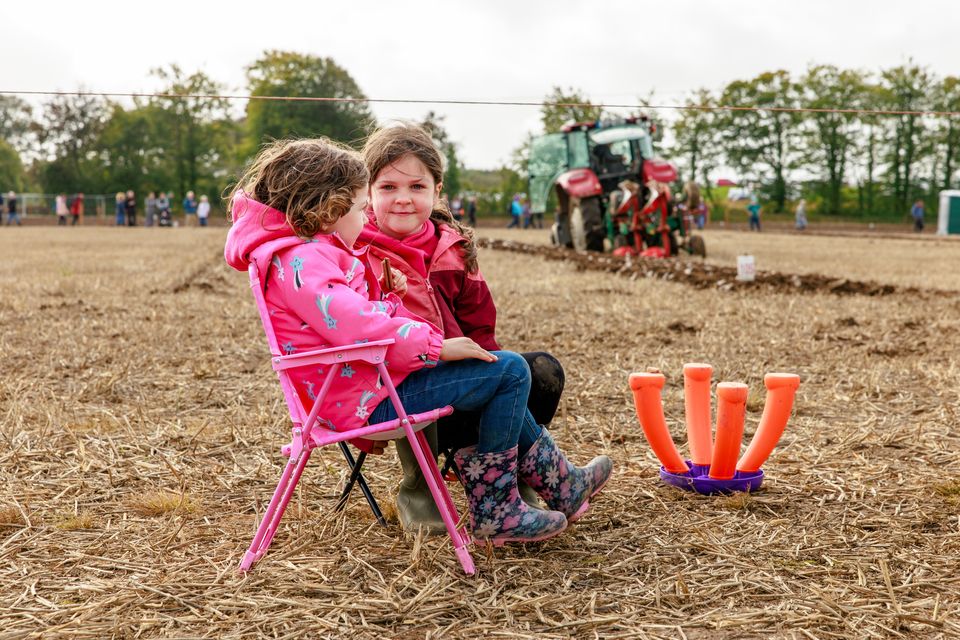 Sisters Holly and Emer Mahon from Co Offaly watch their dad Brian Mahon ploughing on day two of the National Ploughing Championships in Screggan, Tullamore, Co. Offaly.
Pic: Mark Condren