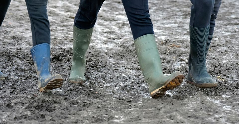 People walking in muddy conditions during the National Ploughing Championships at Tullamore, Co Offaly. Photo: Niall Carson/PA Wire