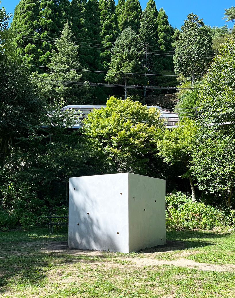 twin concrete cube sculptures link rokko and berlin through tiny video transmission holes