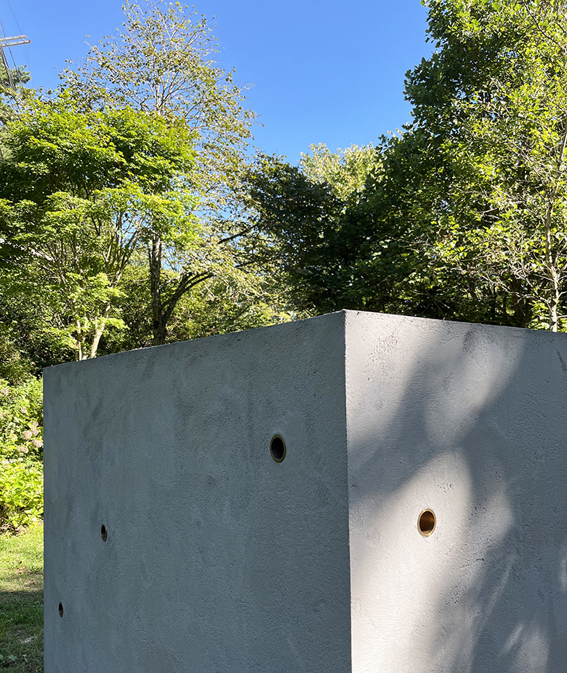 twin concrete cube sculptures link rokko and berlin through tiny video transmission holes