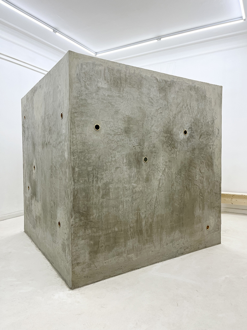 twin concrete cube sculptures link rokko and berlin through tiny video transmission holes