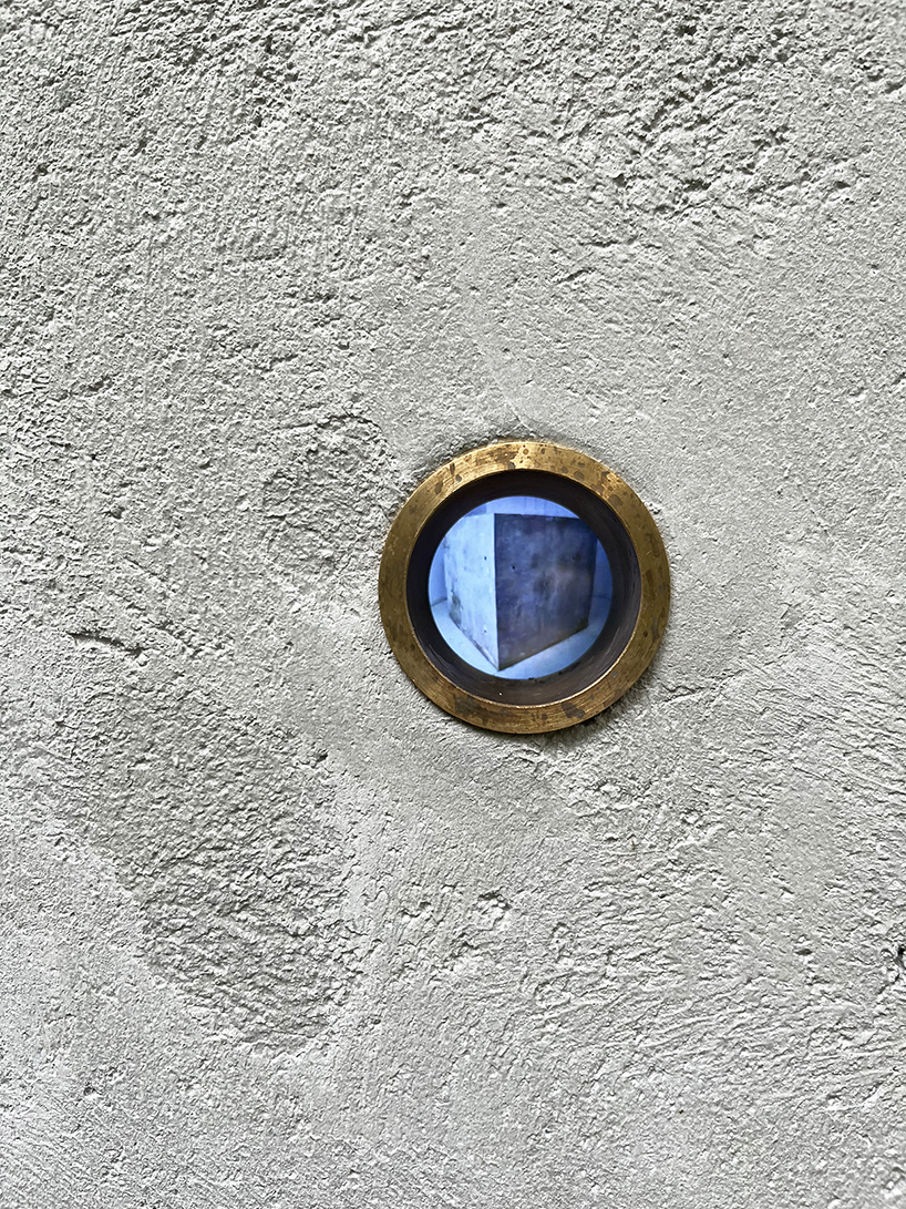 twin concrete cube sculptures link rokko and berlin through tiny video transmission holes