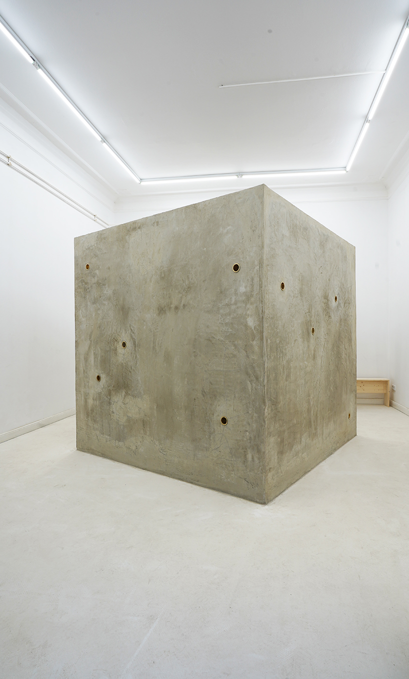 twin concrete cube sculptures link rokko and berlin through tiny video transmission holes