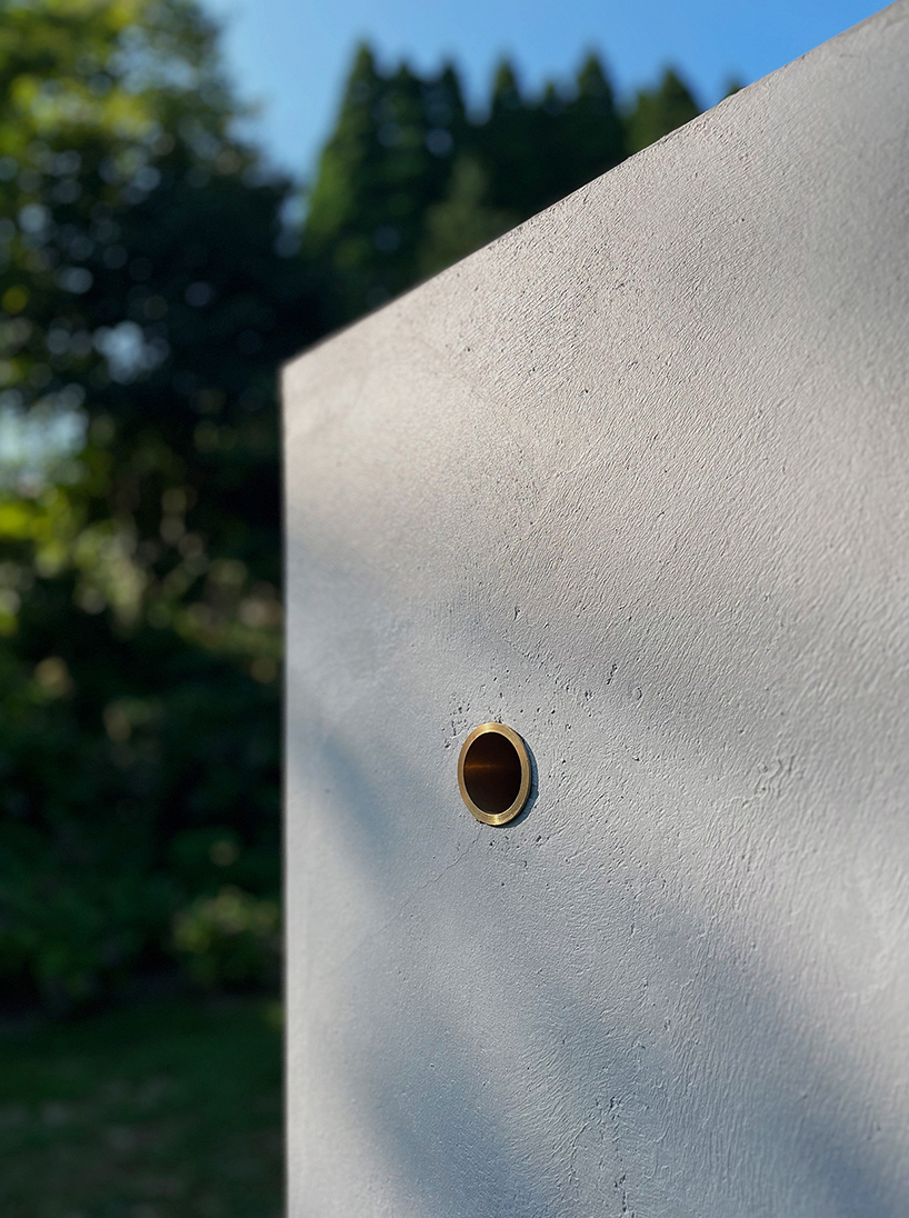 twin concrete cube sculptures link rokko and berlin through tiny video transmission holes