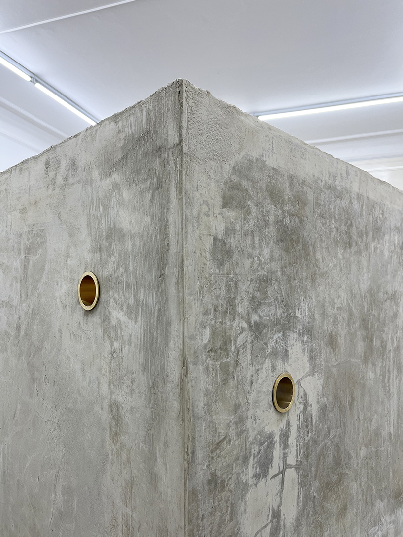 twin concrete cube sculptures link rokko and berlin through tiny video transmission holes