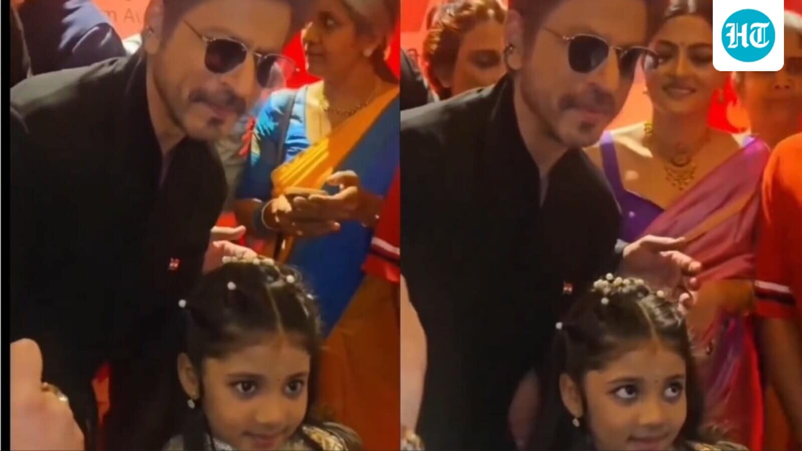 Shah Rukh Khan holds 4-year-old Treesha Thosar gently as they pose together for pics following their National Award win