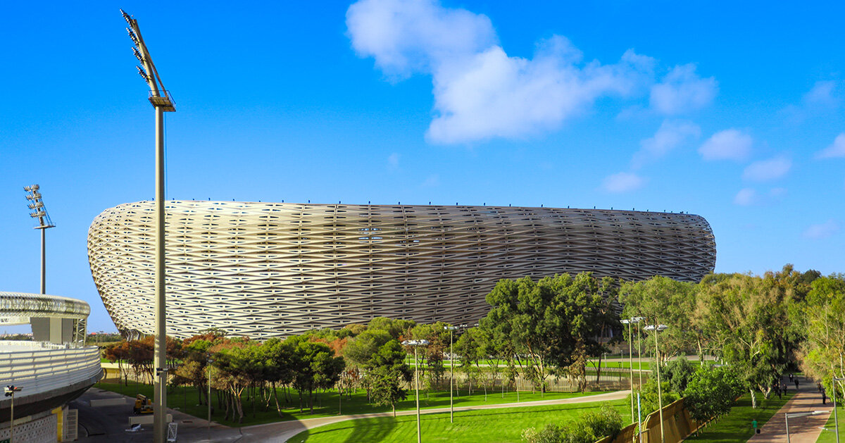 golden triangles compose the facade of populous' stadium in morocco