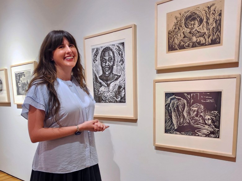 Ana Briz, the UCSB museum’s assistant director and curator of exhibitions, with several works by members of the TGP Collective on view in the exhibition “Mexican Prints: The Garcia-Correa Collection,” including, clockwise from left, “Paul Leroy Robeson” by Leopoldo Méndez, and two works by Fanny Rabel, “El beun maíz” (“The Good Corn”) and “Hambre” (“Hunger”).