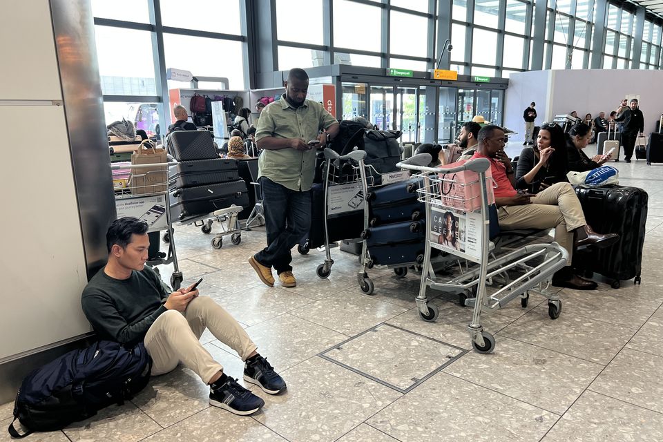 People at London's Heathrow Airport after flights were delayed and cancelled after a cyber attack targeted a service provider for check-in and boarding systems. Photo: PA