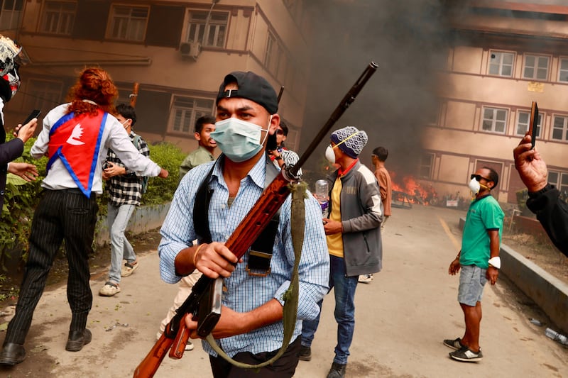 A protester carries a firearm as demonstrators gather outside Nepal's Supreme Court during a protest to condemn the police's deadly crackdown on demonstrators in Kathmandu on Tuesday. Photograph: Prabin Ranabhat/AFP via Getty Images      