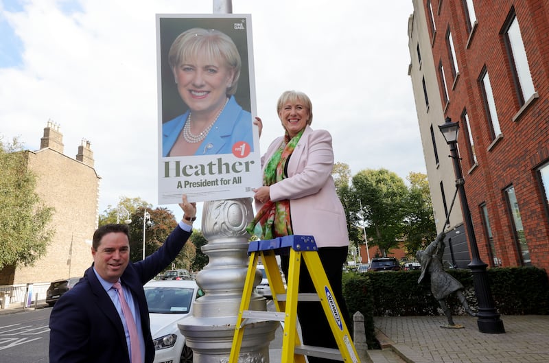 Fine Gael's presidential candidate Heather Humphreys got help from the party's director of elections, Minister for Agriculture Martin Heydon, putting up posters in Dublin on Wednesday. Photograph: Alan Betson/The Irish Times